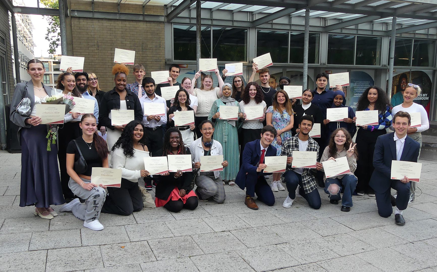 A large group of students celebrating their achievements at award ceremony